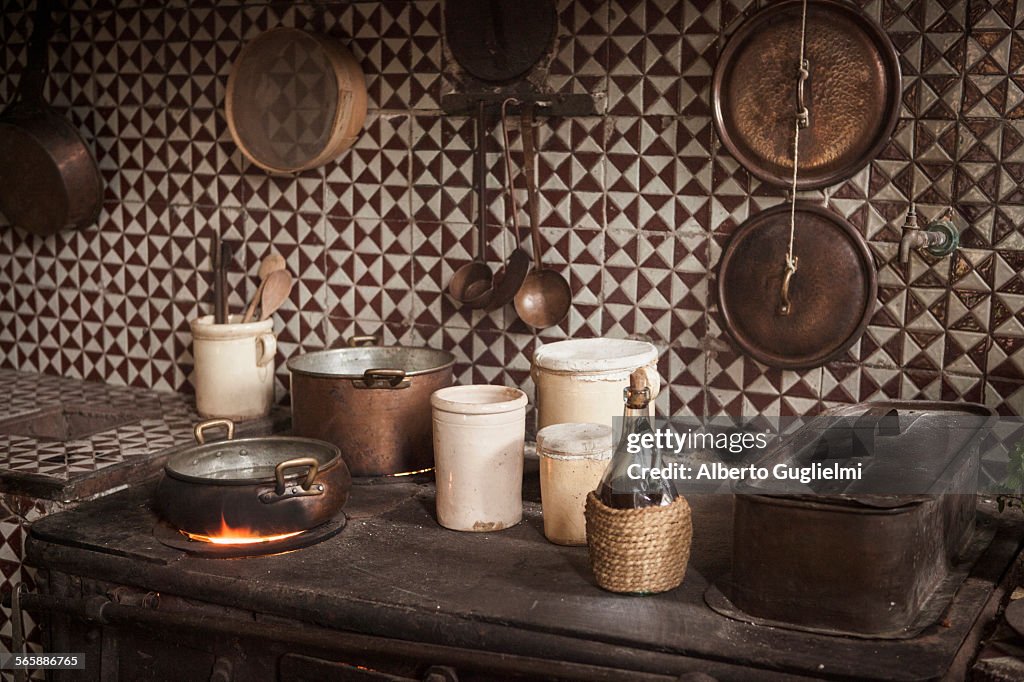 Pots and pans on cast iron stove in kitchen