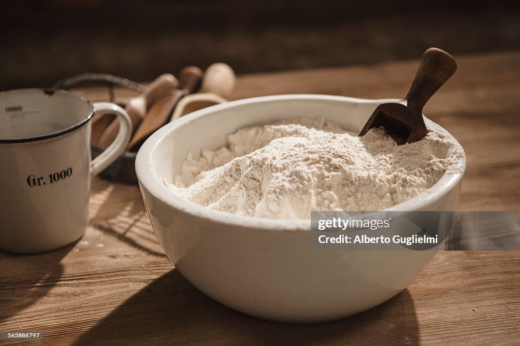 Close up of bowl of flour with scoop