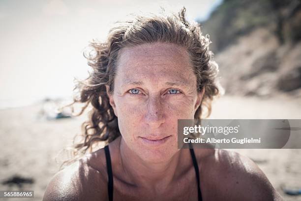 serious caucasian woman on beach - looking at camera serious stock pictures, royalty-free photos & images