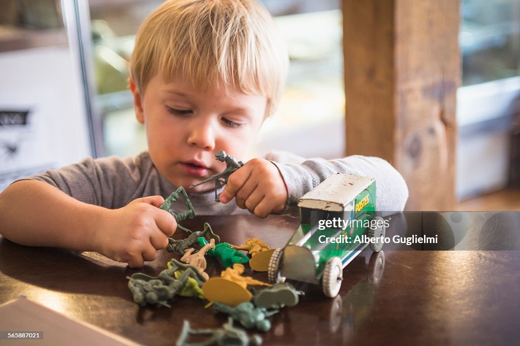 Caucasian boy playing with toys on table