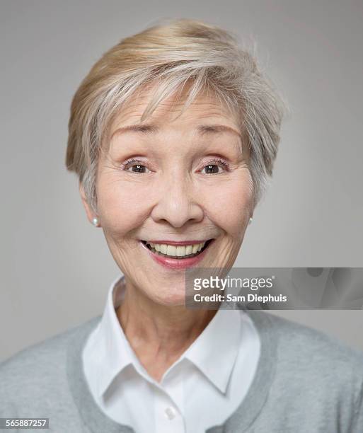 close up of older japanese woman smiling - senior woman studio stock pictures, royalty-free photos & images