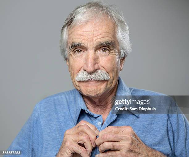 close up of older caucasian man buttoning his shirt - knäppa knappar bildbanksfoton och bilder