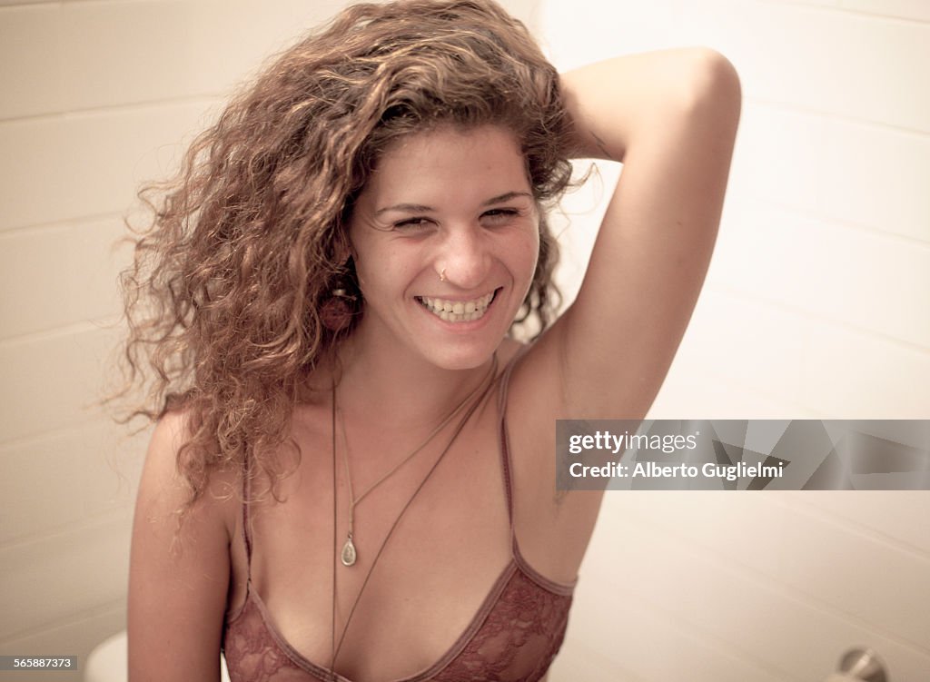 Smiling Caucasian woman showing armpit hair