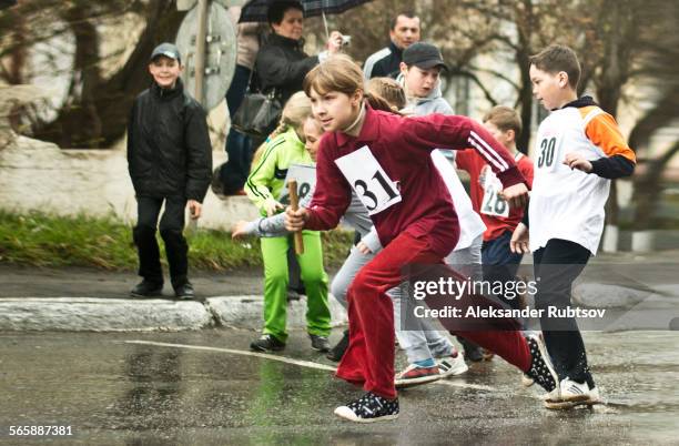 caucasian children racing on street - relay fotografías e imágenes de stock