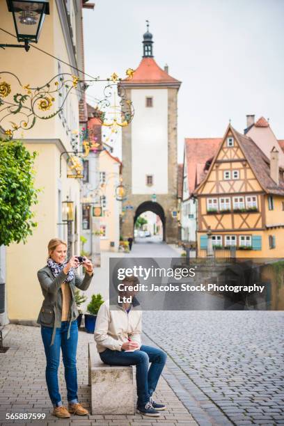 caucasian couple photographing city - bavaria village stock pictures, royalty-free photos & images