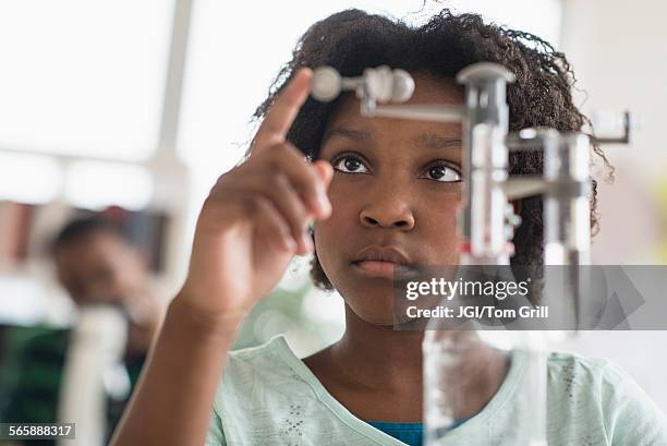 black student doing experiment in science lab - science lab school stock-fotos und bilder
