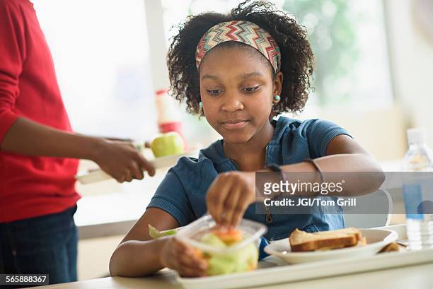 black students eating lunch in school cafeteria - serious kid stock pictures, royalty-free photos & images