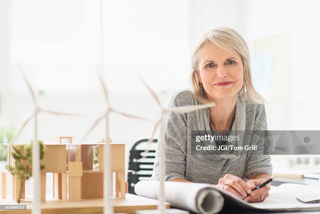 Older Caucasian architect sitting in office
