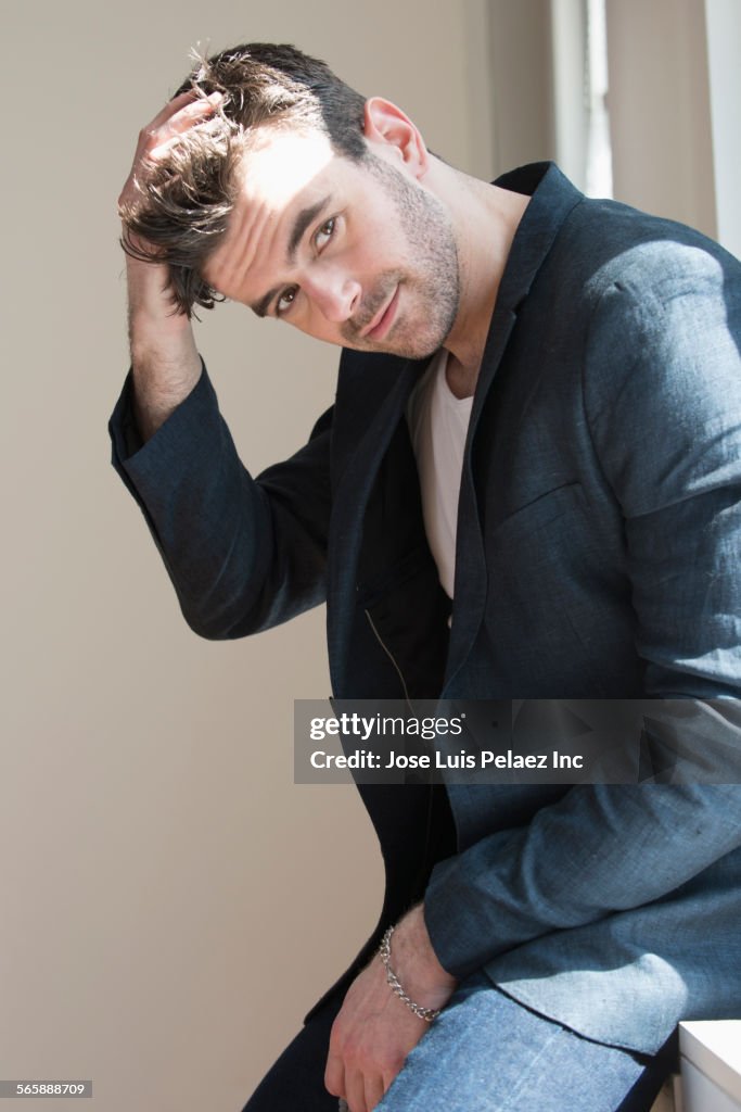 Close up of Caucasian businessman on window sill