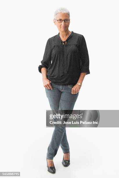 mixed race woman standing with thumbs in pockets - full body isolated stockfoto's en -beelden