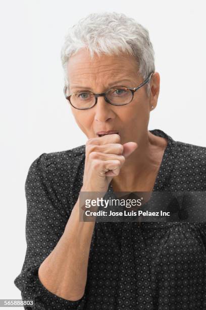 close up of mixed race woman coughing - woman cough stock-fotos und bilder