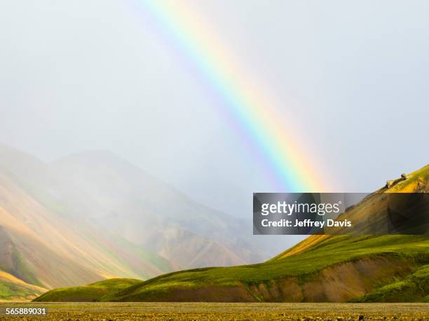 rainbow over rural fields and hillside, landmannalaugar, fjallabak nature reserve, iceland - landscap with rainbow fotografías e imágenes de stock