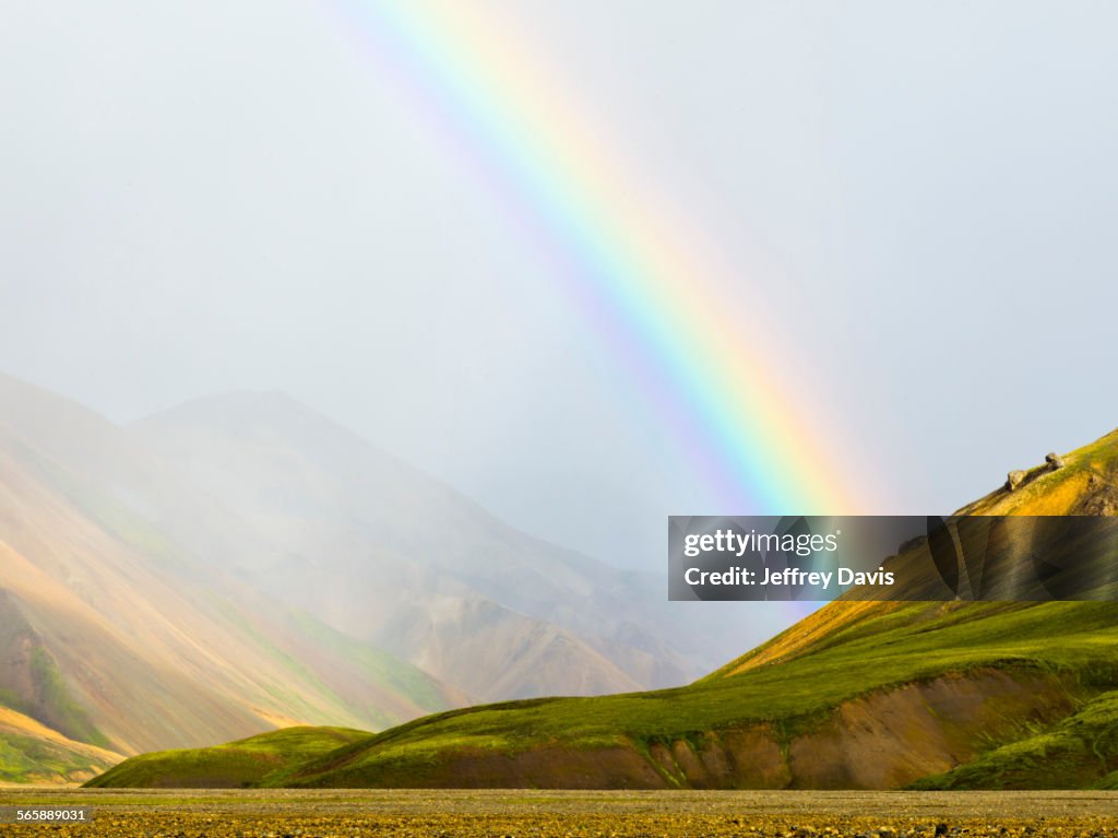 Rainbow over rural fields and hillside, Landmannalaugar, Fjallabak Nature Reserve, Iceland