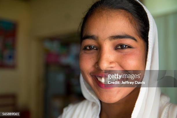 close up of smiling girl wearing headscarf - bangladesh stock-fotos und bilder