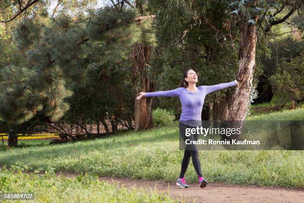 caucasian athlete walking on dirt path in park - signaling pathways stock pictures, royalty-free photos & images