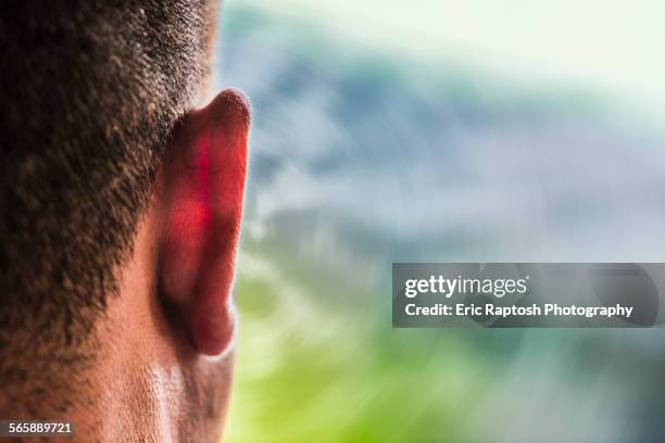 close up of ear of caucasian man and sound waves - ear close up stock-fotos und bilder