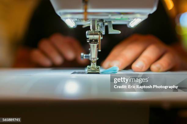 close up of caucasian dressmaker using sewing machine - sewing machine imagens e fotografias de stock