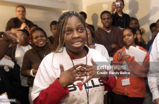 New homeowner Tenisha Bray expresses her joy to volunteers assembled for a service project to paint her newly constructed house on January 13, 2006...