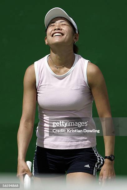 Akiko Nakamura of Japan smiles after missing a shot during a practice session prior to the Australian Open at Melbourne Park January 15, 2006 in...