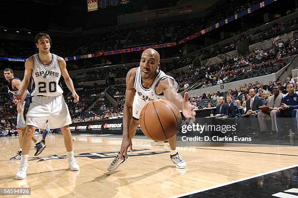 Bruce Bowen of the San Antonio Spurs dives for the ball, with teammate Manu Ginobili watching, while playing against the Memphis Grizzlies during the...