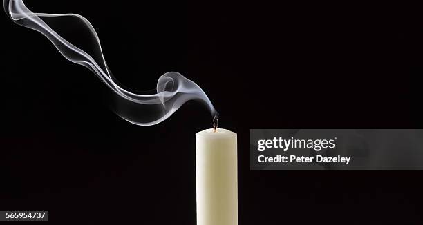 smoke trailing from extinguished white candle - muerte fotografías e imágenes de stock