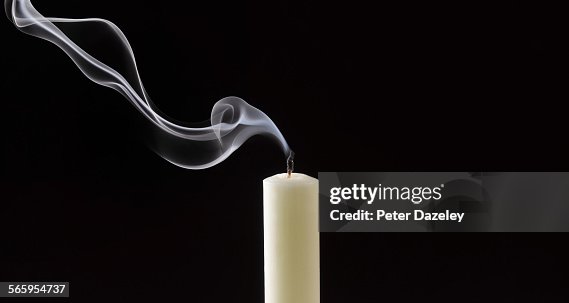 Smoke trailing from extinguished white candle Smoke trailing from extinguished white candle
