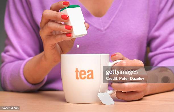 artificial sweetener in tea - sweet food stock pictures, royalty-free photos & images