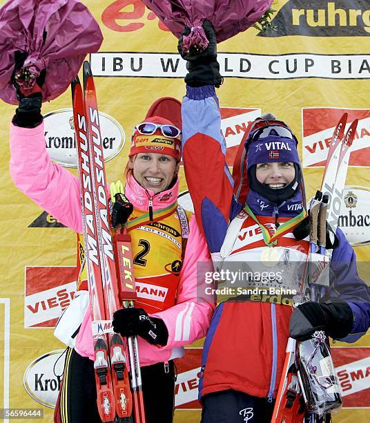 Kati Wilhelm of Germany and Liv Grete Poiree celebrate their places after the women's 10 km pursuit of the Biathlon World Cup on January 15, 2006 in...