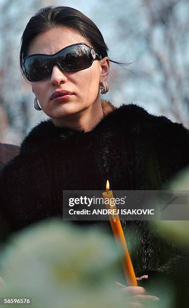 Serbian folk singer Svetlana Raznatovic, the widow of notorious warlord Zeljko Raznatovic-Arkan, holds a candle during a memorial service in...