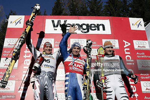 Kalle Palander of Finland, second place, Giorgio Rocca of Italy, first place, and Alois Vogl of Germany, third place celebrate on the podium after...