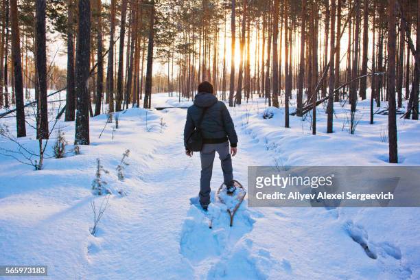 Mari man snowshoeing on snowy path