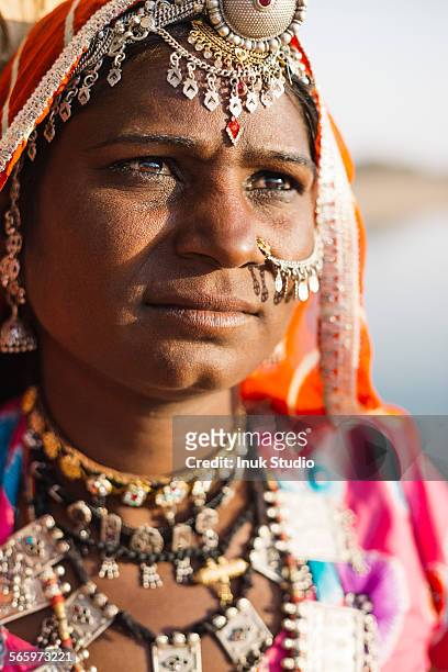 close up of indian woman wearing traditional jewelry - rajasthani women stock-fotos und bilder