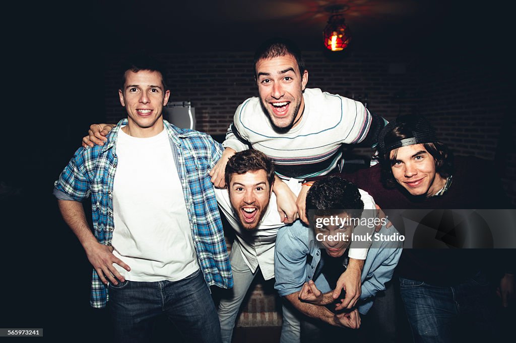 Laughing men posing at party at night