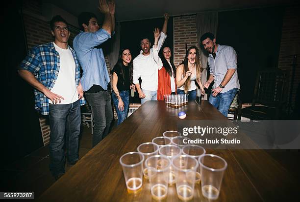 friends playing beer pong at party - man party night bar posing stock pictures, royalty-free photos & images