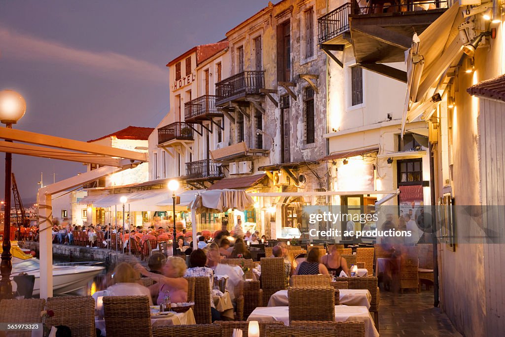 Time lapse view of sidewalk cafe at sunset, Mykonos, Cyclades, Greece