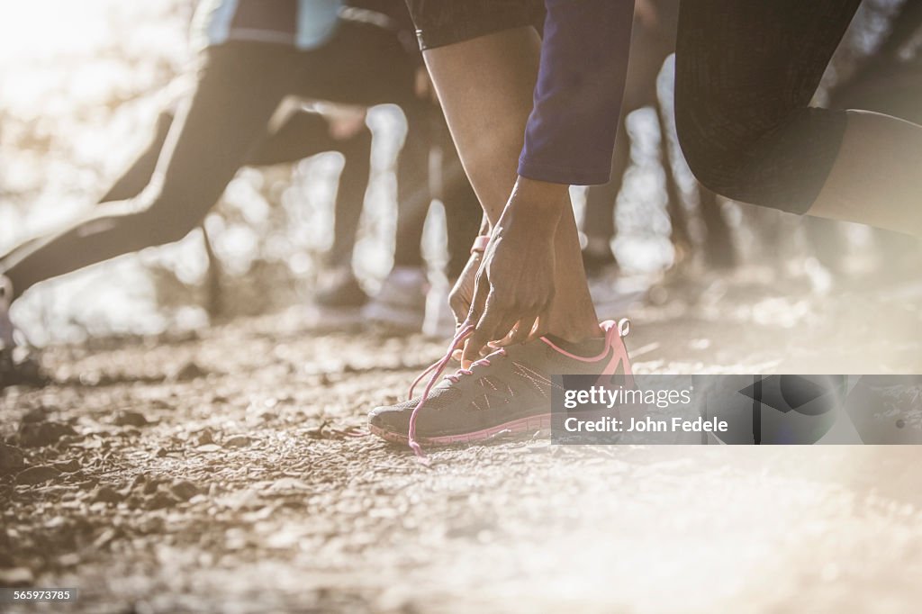 Close up of athlete tying shoe