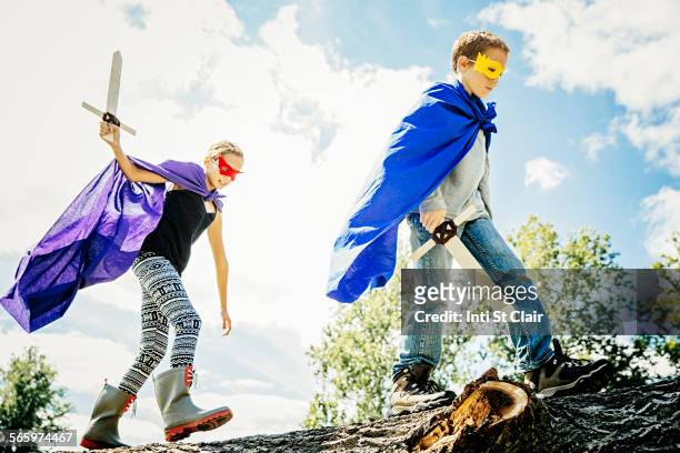 caucasian children in costumes playing with swords - summer super 8 stockfoto's en -beelden