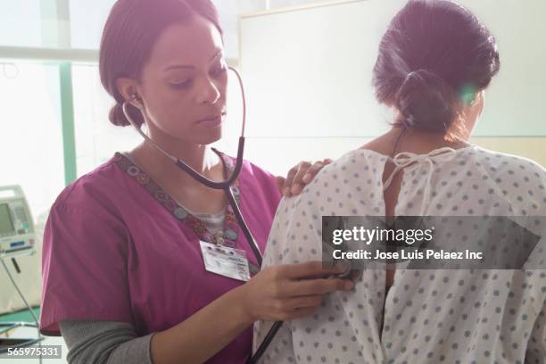 nurse listening to heartbeat of patient in hospital room - patient hospital selective focus stock pictures, royalty-free photos & images