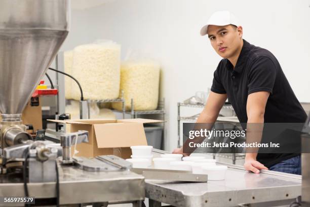 worker packing product in factory - the popcorn factory stock pictures, royalty-free photos & images