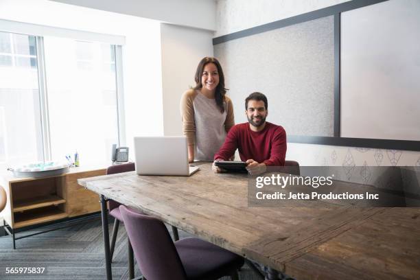 business people smiling in office meeting - porträt frau blick in ferne stock-fotos und bilder