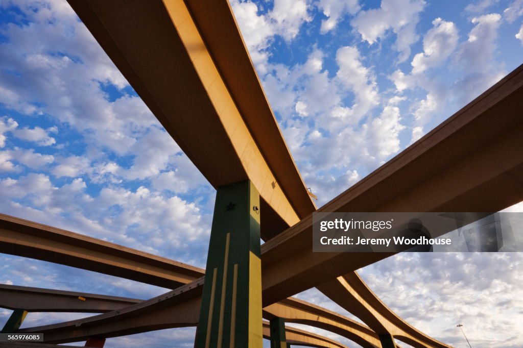 Low angle view of highway overpasses under blue sky