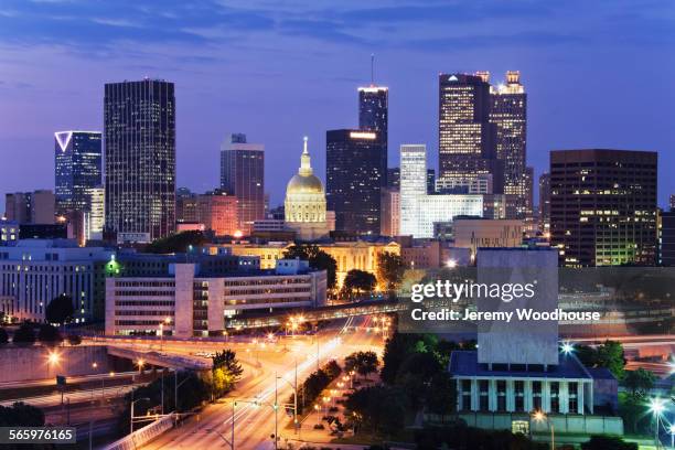 highway traffic to atlanta cityscape at night, georgia, united states - atlanta skyline car stock pictures, royalty-free photos & images