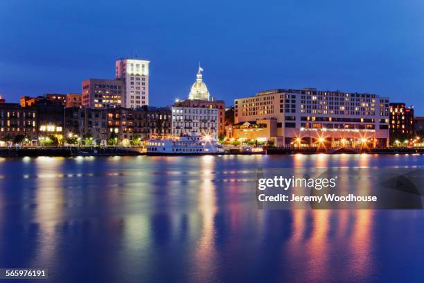 illuminated buildings in savannah city waterfront at night, georgia, united states - savannah stock-fotos und bilder