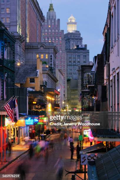 blurred motion view of tourists on bourbon street at night, new orleans, louisiana, united states - new orleans french quarter photos et images de collection