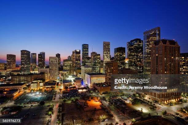 high rise buildings in houston cityscape illuminated at sunset, texas, united states - houston texas stock pictures, royalty-free photos & images