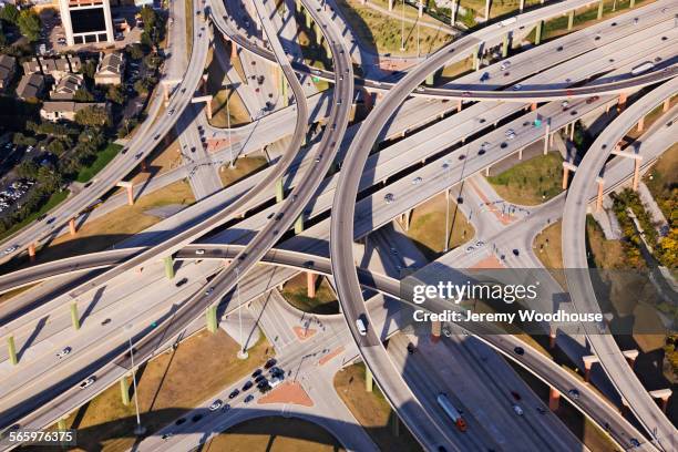 aerial view of traffic on highway interchange roads - intertwined stock-fotos und bilder