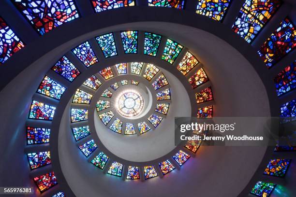 low angle view of spiraling stained glass windows in church - stained glass stock pictures, royalty-free photos & images