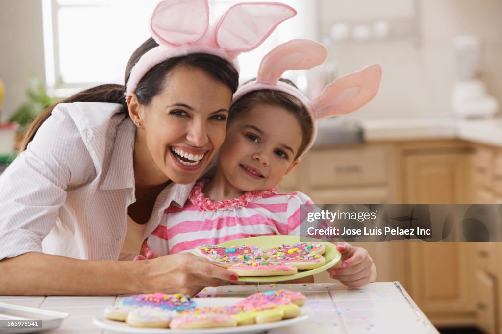 Mother and daughter decorating Easter cookies