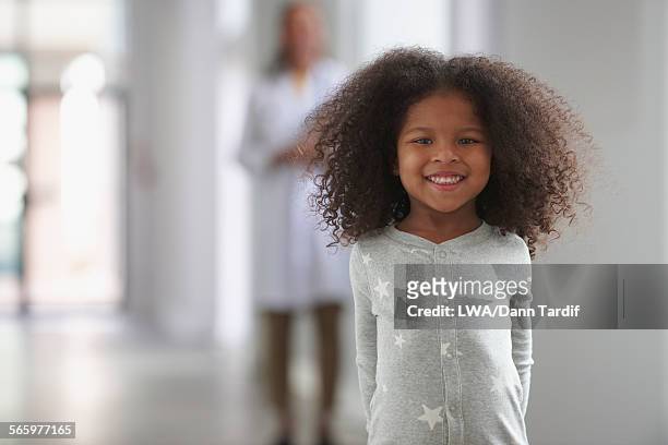 smiling girl standing in hospital hallway - kids proud bildbanksfoton och bilder