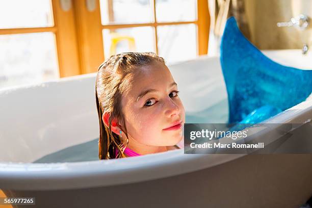 caucasian girl wearing mermaid tail in bath - mermaid tail stock pictures, royalty-free photos & images